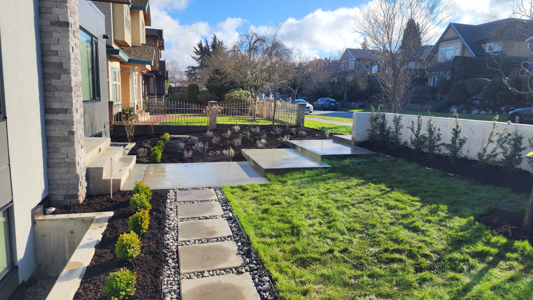 Front yard with paver pathway, stepping stones, fresh sod lawn and planting beds